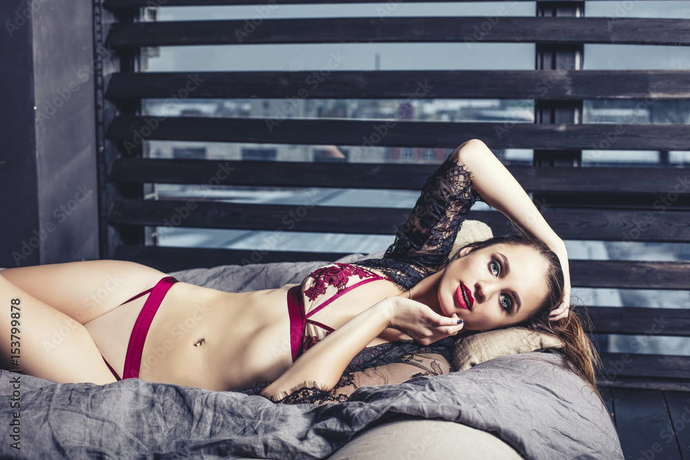 Fototapeta premium Young beautiful woman in luxury lingerie fashionable brunette in the bedroom