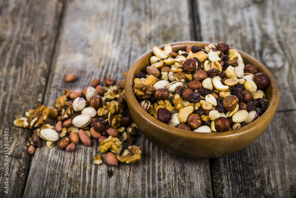 Nuts in a wooden bowl on a wooden table. Nuts in a wooden bowl on a wooden table.