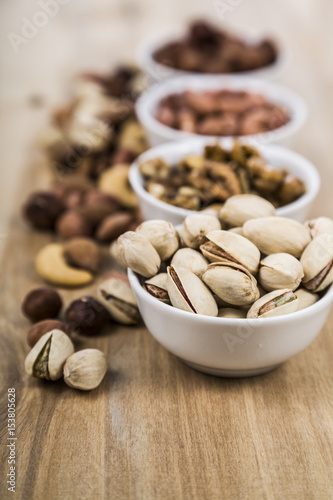 Nuts in a plate on a wooden table.