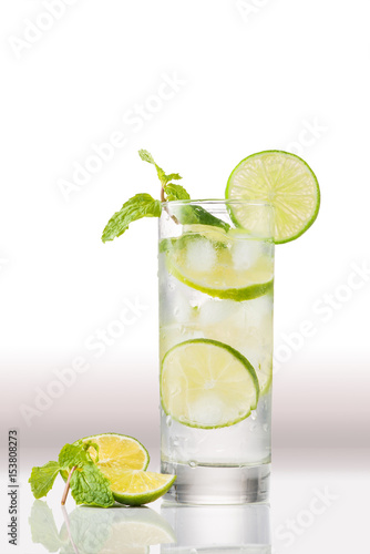 Full glass of water with lemon and mint isolated on white background