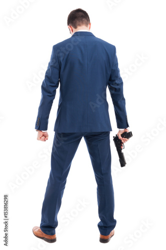 Powerful killer with a gun standing with back