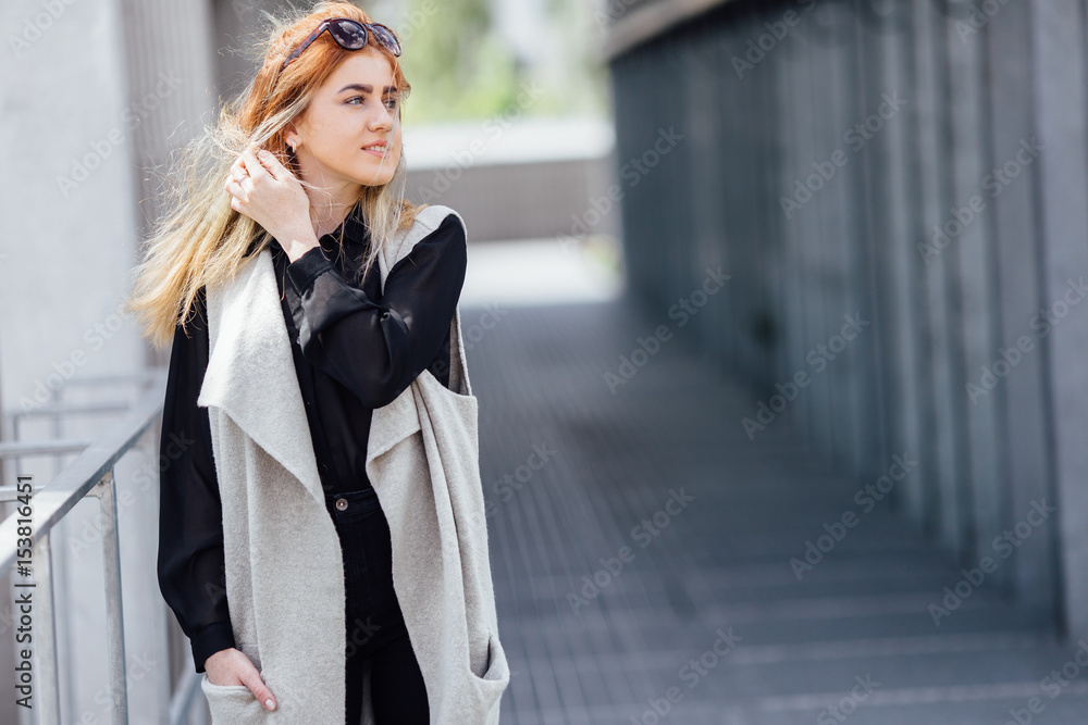 Fototapeta premium One girl pose to camera near the wall with sunlight
