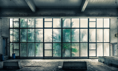 Tableau sur plexiglas Vieux bâtiments abandonnés The view from an old, abandoned factory on the inside with nice window light  © VisitorImages