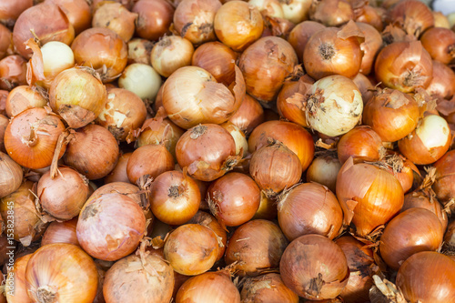 A big pile of golden onion - food background