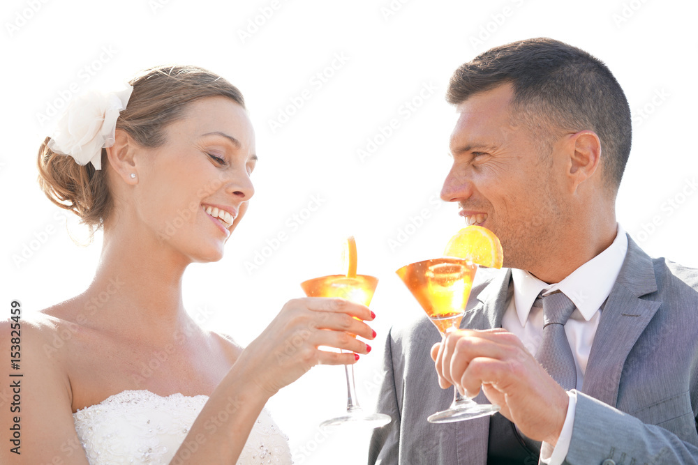 Bride and groom cheering with cocktails Bride and groom cheering with cocktails