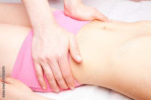 Girl receiving osteopathic treatment of her pelvis