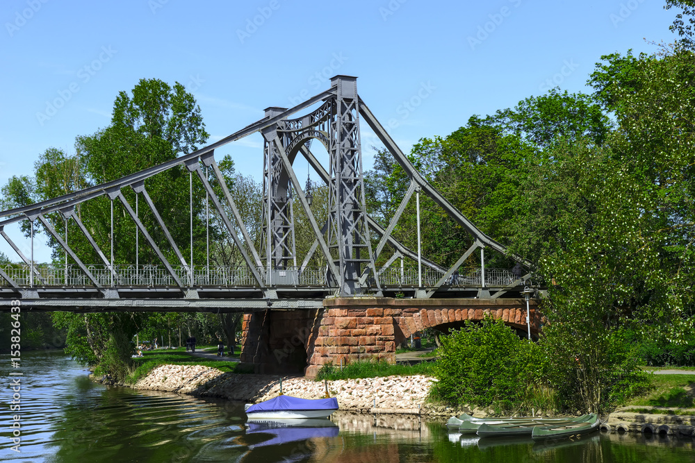 Old Iron Bridge across the river, on a stone base