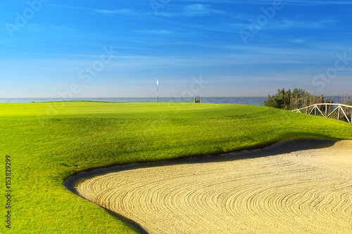 Green golf field on the sunny coast of Mediterranean sea