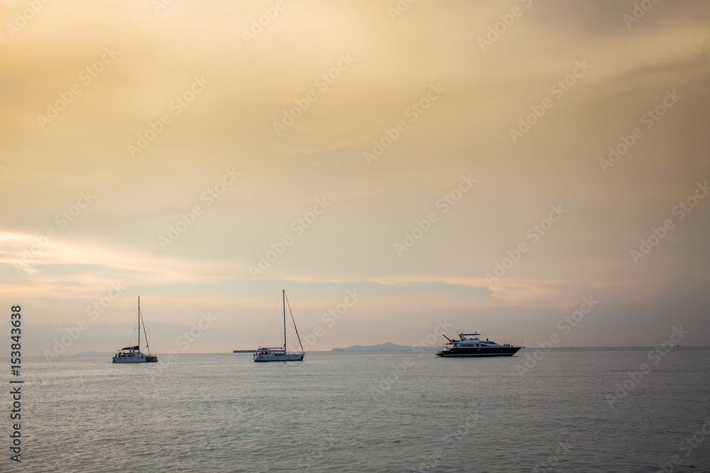 Boat in the sea with afternoon orange light Boat in the sea with afternoon orange light