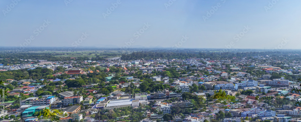 Cityscape view from top of the hill or mountain with white cloud and blue sky, view from top of Khao Sakae Krang mountain, Uthai Thani province, Thailand