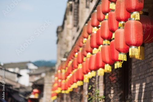 Row of chinese lanterns hanging on a building