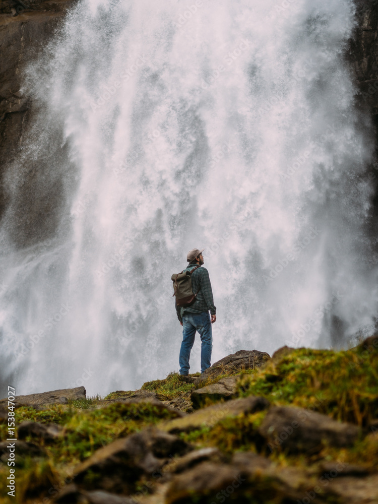 Man on background of waterfall Man on background of waterfall