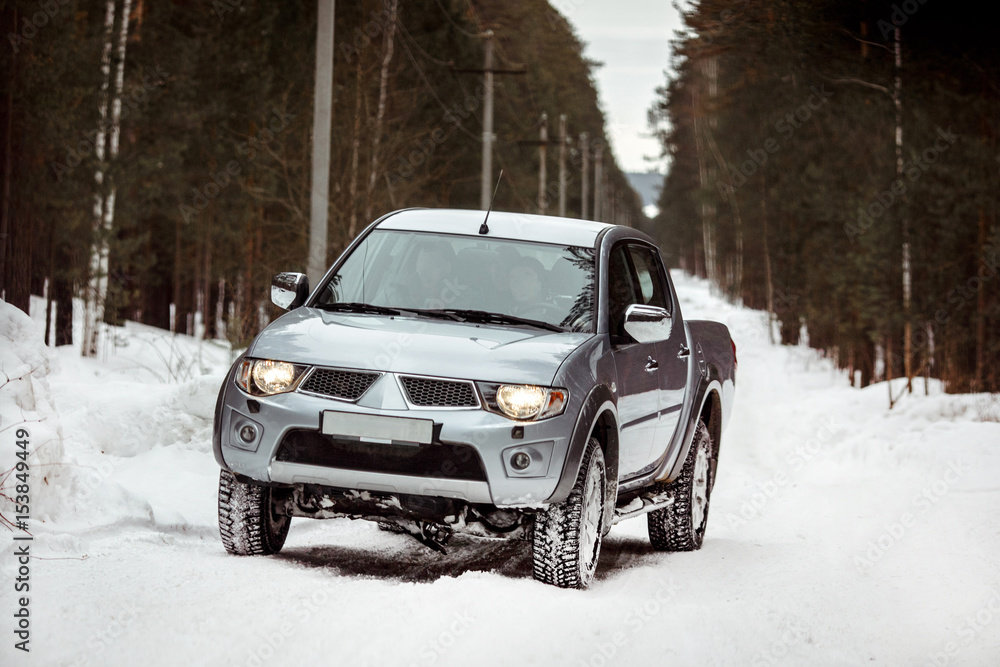 SUV rides on a winter forest road