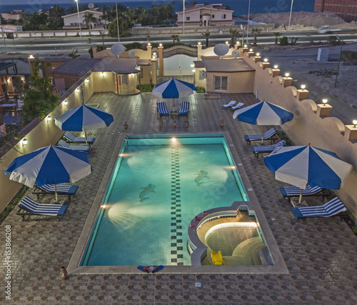 Aerial view of tropical holiday villa swimming pool atnight photo