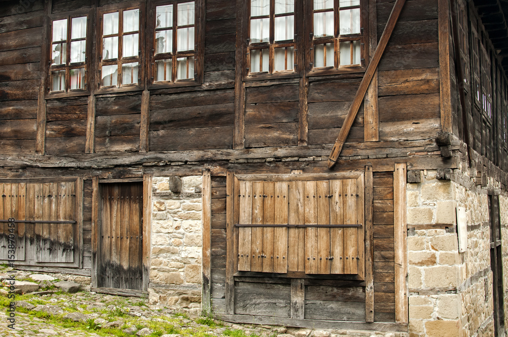 Weathered wooden boards facade of old countryhouse