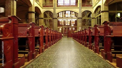 Fly to the entrance of a church between the church benches, Aerial shot photo