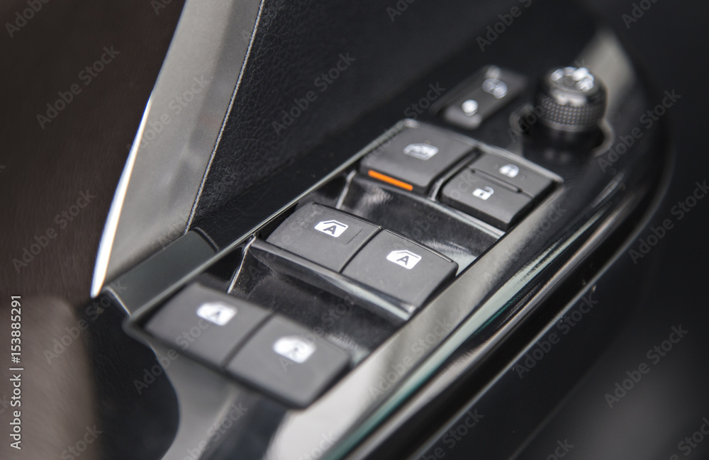 Car interior details of door handle panel with windows controls and adjustments Car interior details of door handle panel with windows controls and adjustments