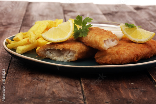 traditional British fish and chips on wooden background