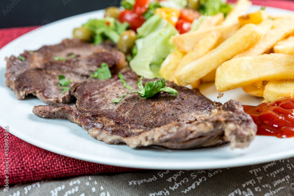 juicy steak beef meat with tomato and french fries