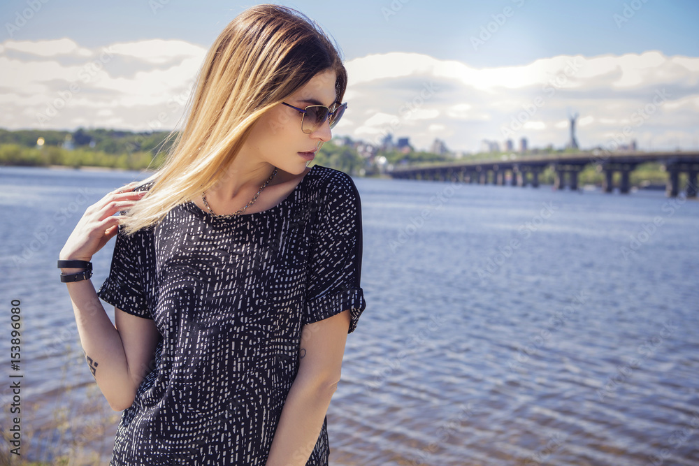 Beautiful caucasian woman in casual outfit outdoors walking, spending time in city. Sunny warm day. Stylish girl Beautiful caucasian woman in casual outfit outdoors walking, spending time in city. Sunny warm day. Stylish girl