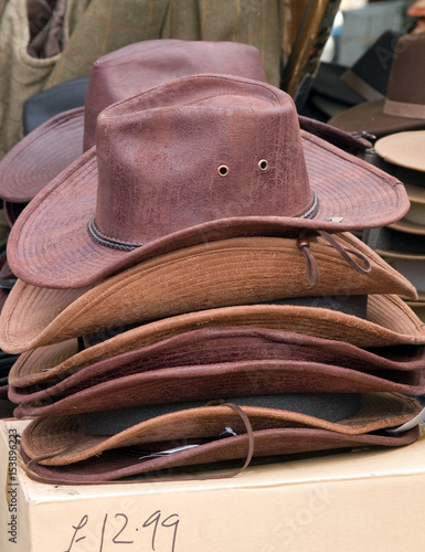 waxed faux-leather cowboy-inspired type hats for sale on a stall at a country fair in the UK.