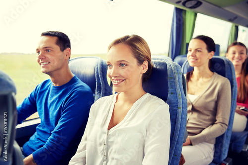 group of happy passengers in travel bus