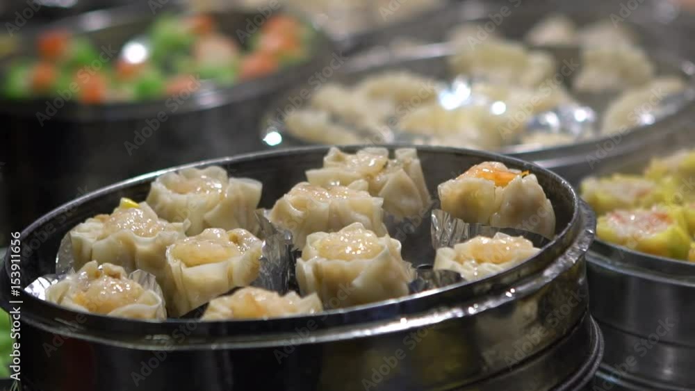 Slow motion vendor preparing and selling Shaomai and customers at Asian Street Food Market in Taiwan. Dumpling is a chinese traditional food at Oriental Night Market. Restaurant in downtown-Dan Slow motion vendor preparing and selling Shaomai and customers at Asian Street Food Market in Taiwan. Dumpling is a chinese traditional food at Oriental Night Market. Restaurant in downtown-Dan