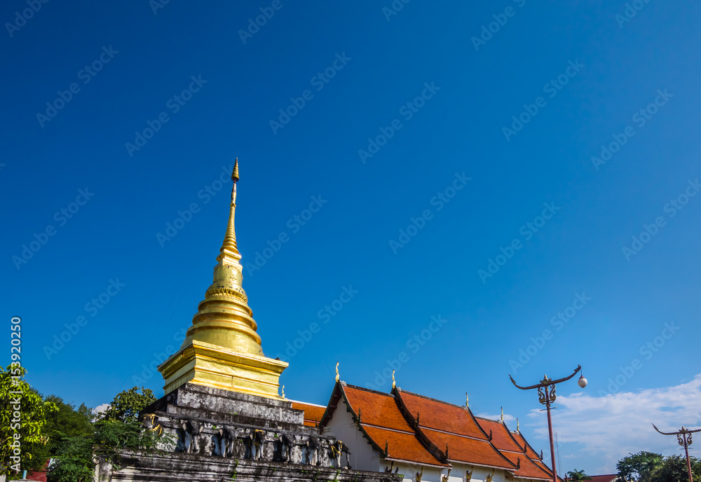 Fototapeta premium Wat Phra That Chang Kham Worawihan (Chang Kham temple), ancient landmark of Nan province, in north of Thailand. Temple age more than 600 years. A famous place of tourism to visit.