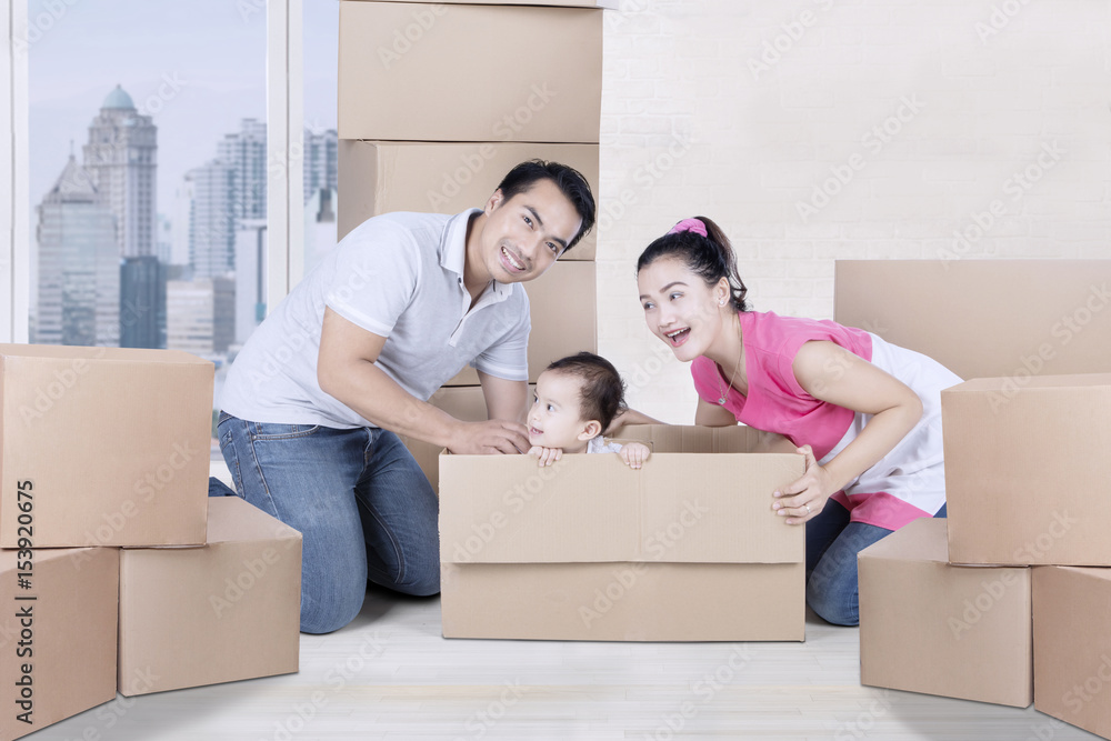 Young family plays with boxes in the apartment Young family plays with boxes in the apartment