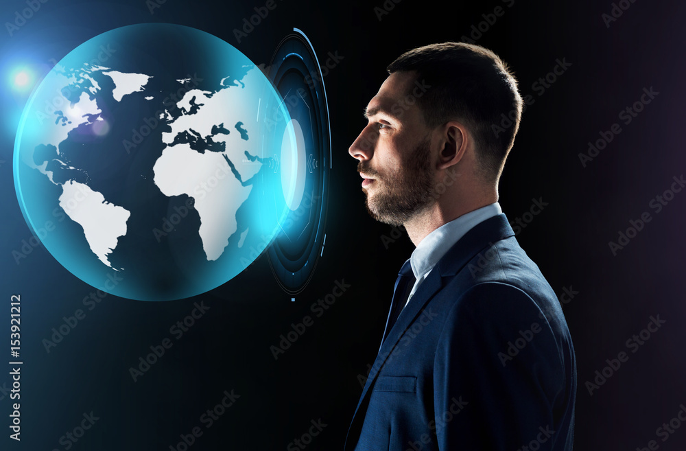 businessman looking at virtual earth projection businessman looking at virtual earth projection