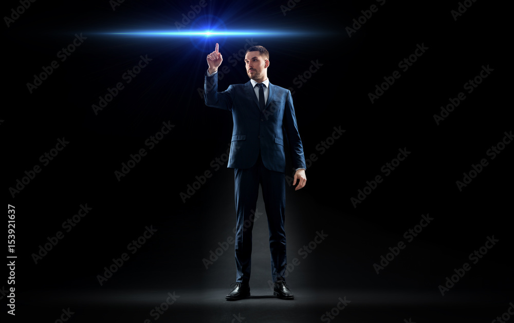 businessman in suit pointing finger to laser light businessman in suit pointing finger to laser light