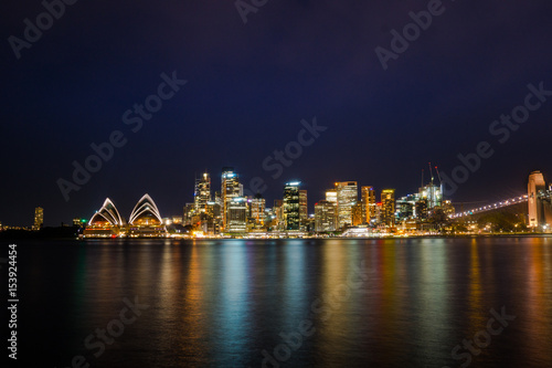 Long exposure night shot of city center of Sydney skyline looking over the harbor