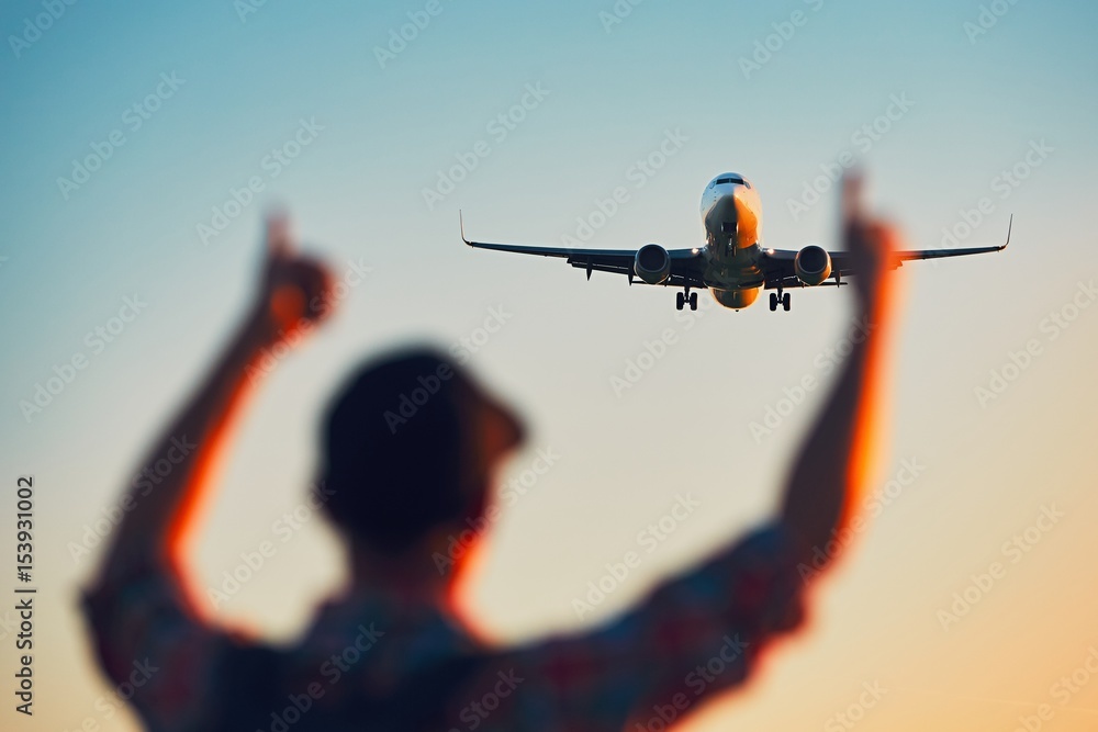 Fototapeta premium Happy traveler watching airplane landing