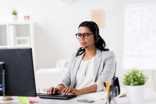 businesswoman with headset and computer at office