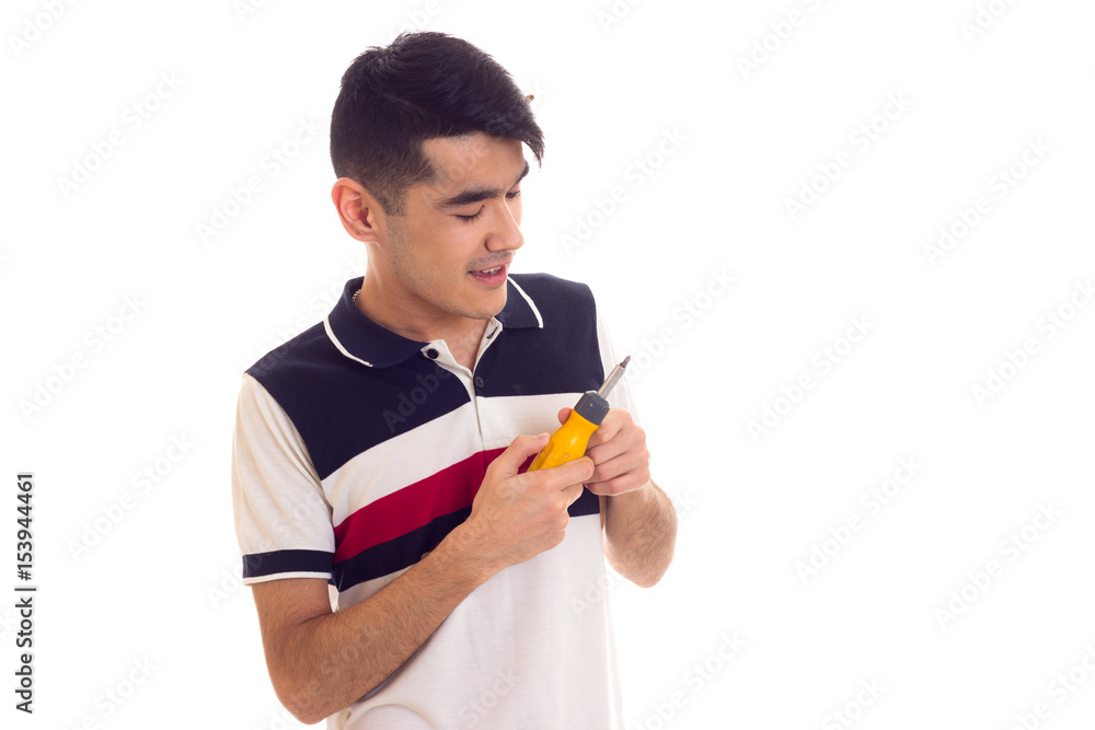 Young man holding a screwdriver Young man holding a screwdriver