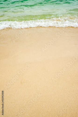 summer background of blue wave on the sandy beach