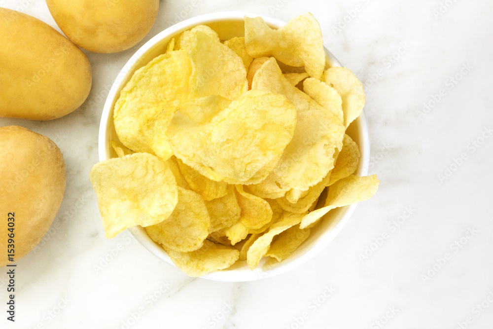 Chips with potatoes, shot from above with copyspace Chips with potatoes, shot from above with copyspace