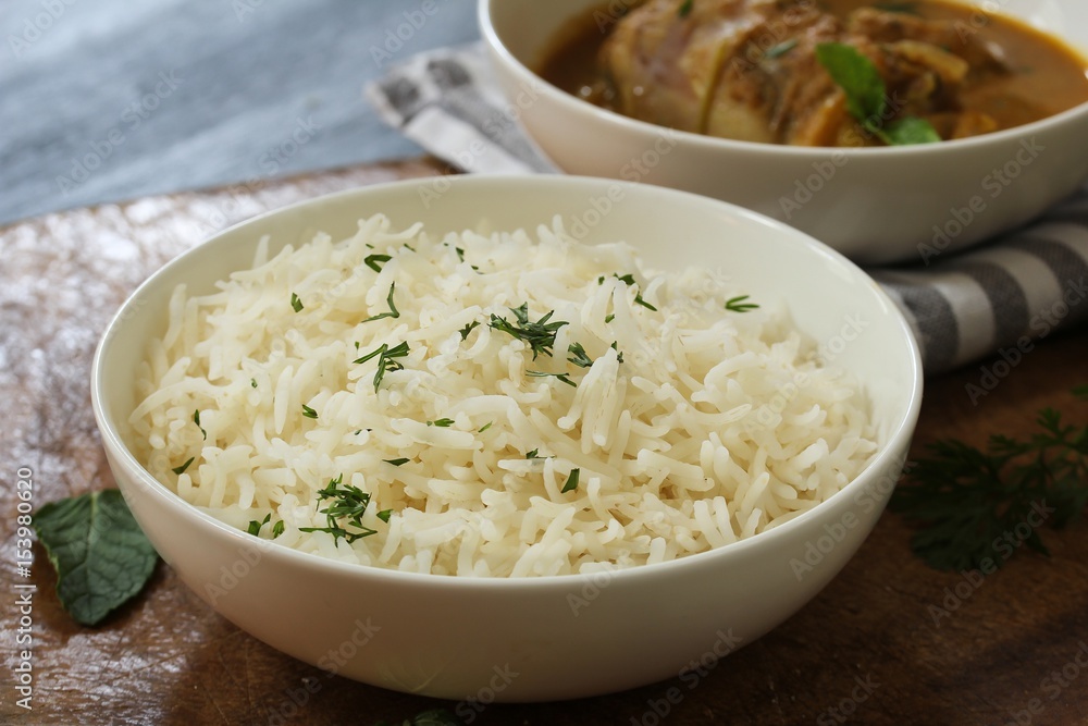Cooked Long grain Basmati Rice served with chicken curry, selective focus Cooked Long grain Basmati Rice served with chicken curry, selective focus
