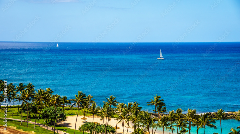 Fototapeta premium Sail Boat in the Pacific Ocean just off the coast at the resort community of Ko Olina on the West Coast of the Hawaiian island of Oahu