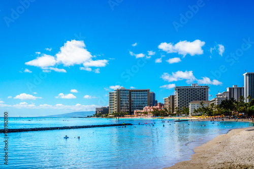 Waikiki Beach, with its many resorts under blue sky and white sand, makes it one of the world's most famous beaches. Located in Honolulu on the Hawaiian island of Oahu  © hpbfotos