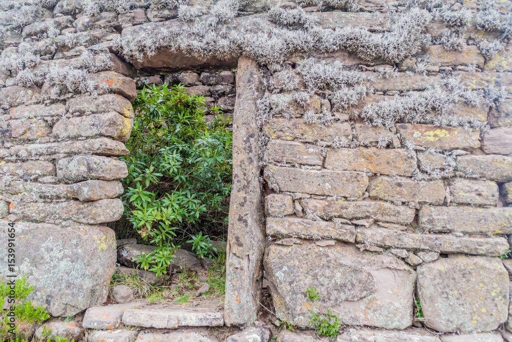 Door in a ruined house on Taquile island in Titicaca lake, Peru