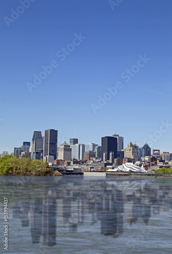 View of Montreal city with reflection on the water, day © gdvcom