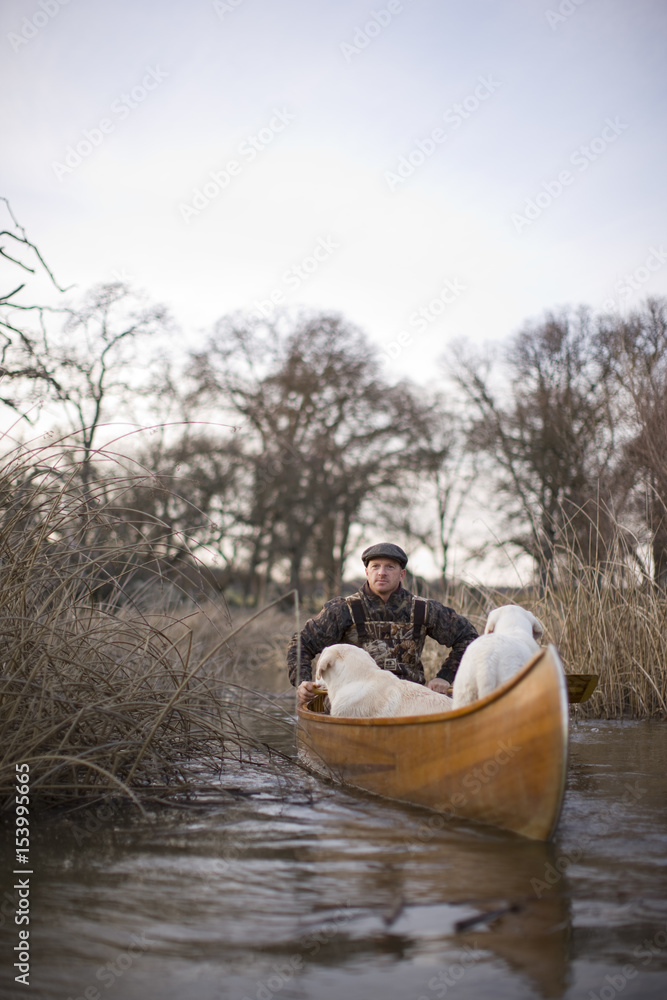 Man and his two dogs in a canoe. Man and his two dogs in a canoe.