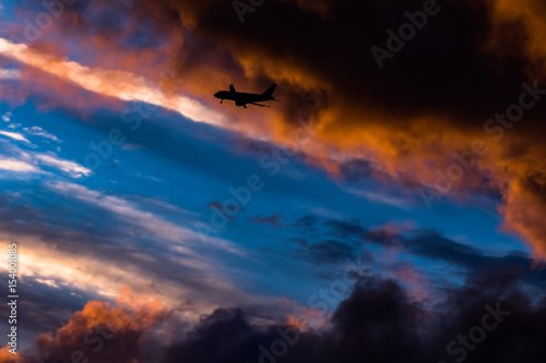 Airplane landing in sunset colors
