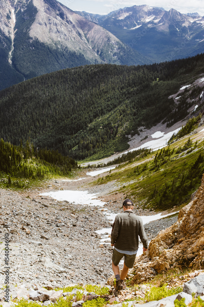 Naklejka premium Hiker hiking in mountain and forest trail 