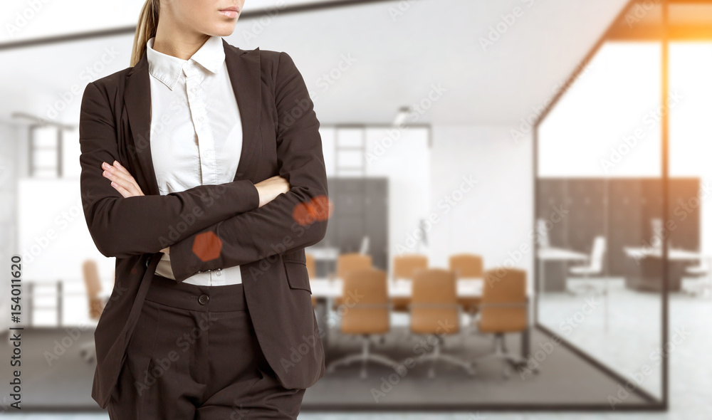 Fototapeta premium Confident woman in office hall, close up