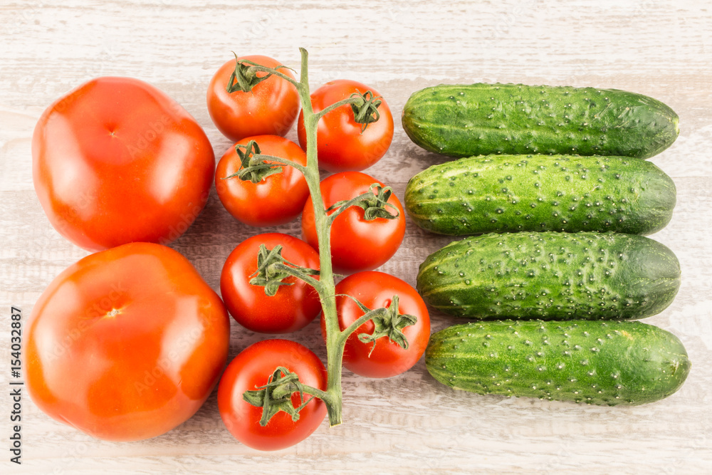Cucumber, tomato, pepper and fennel on a white wooden background close up. Cucumber, tomato, pepper and fennel on a white wooden background close up.