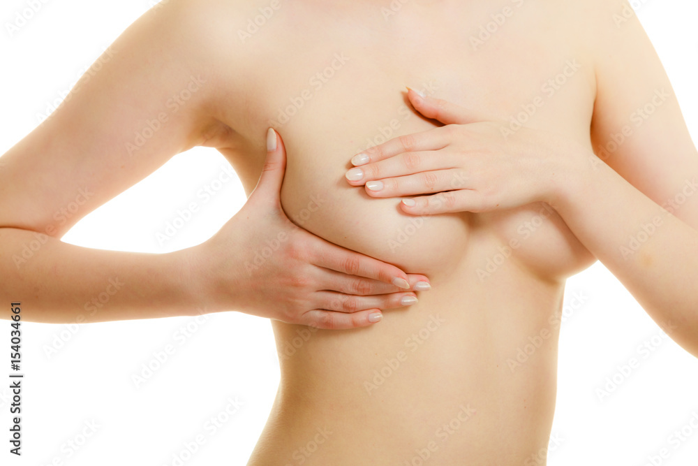 Woman examining her breasts for breast cancer Woman examining her breasts for breast cancer