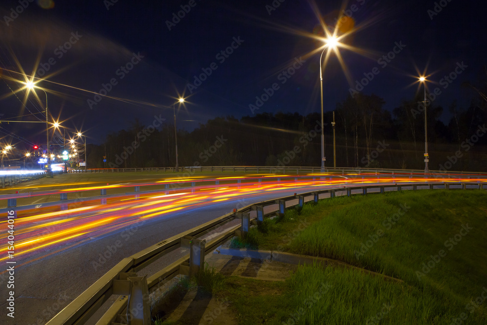 Urban city road with car light trails at night	