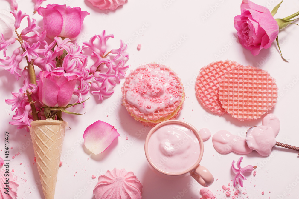 Flowers in a waffle cone with yogurt and meringues on white background Flowers in a waffle cone with yogurt and meringues on white background